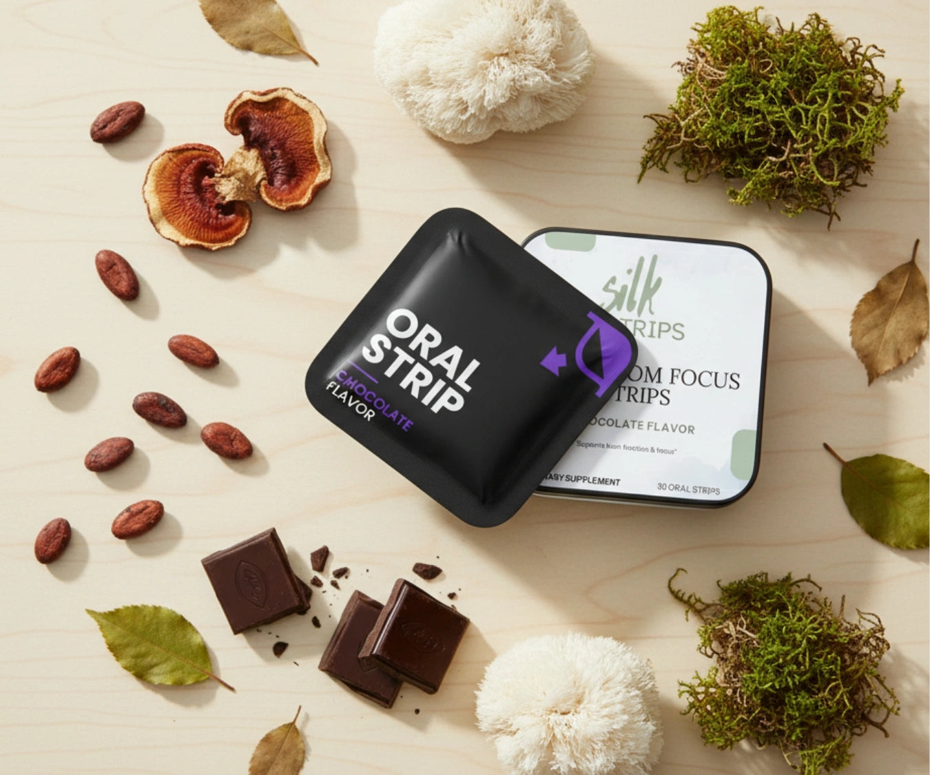Silk Strips packaging surrounded by Lion's Mane mushrooms, Reishi, dark chocolate, and cacao beans.